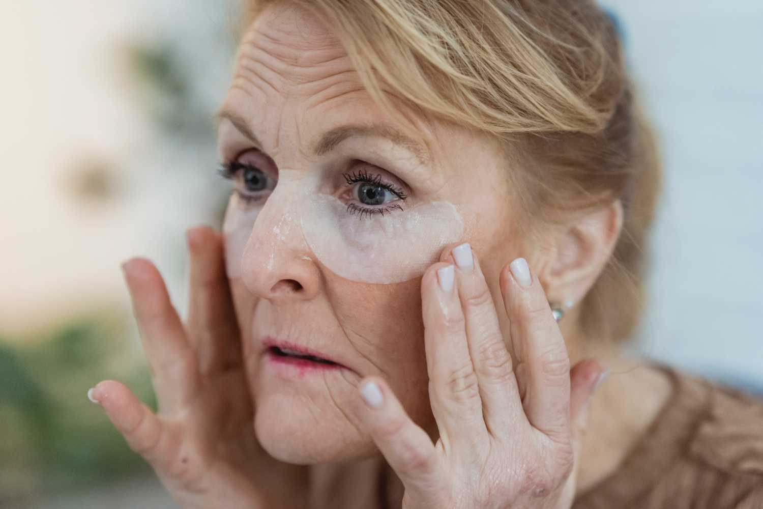woman with mature skin using natural facial cleanser