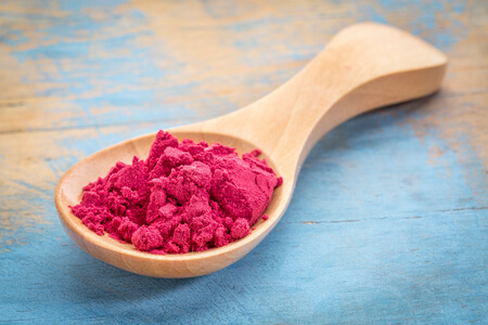 How To Make Delicious Fruit Powder At Home 6 wooden spoon filled with raspberry fruit powder