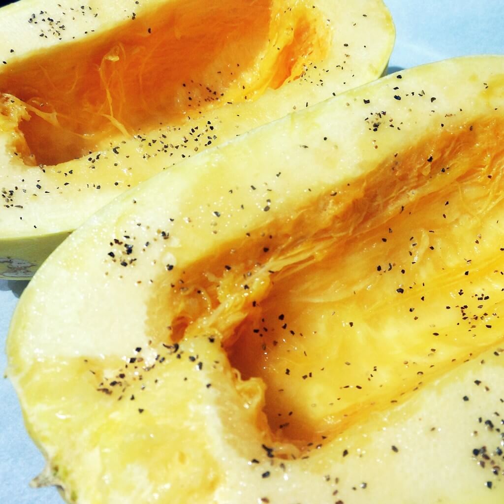 How to Cook Spaghetti Squash 5 halved spaghetti squash covered with olive oil and sale and pepper