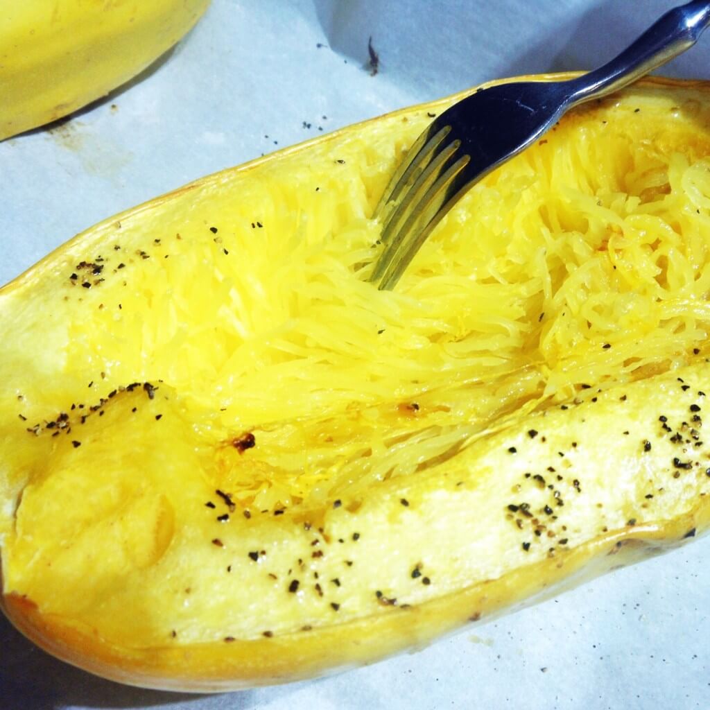 How to Cook Spaghetti Squash 6 using a fork to remove the spaghetti strands from spaghetti squash