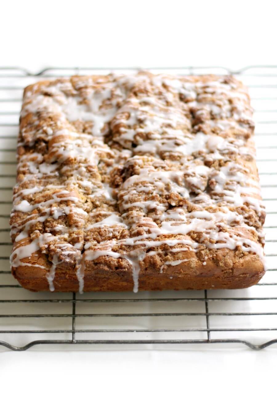 Don't Miss These Recipes Using Coconut Yogurt 9 A fresh coffee cake on an airing rack with glaze dripping down