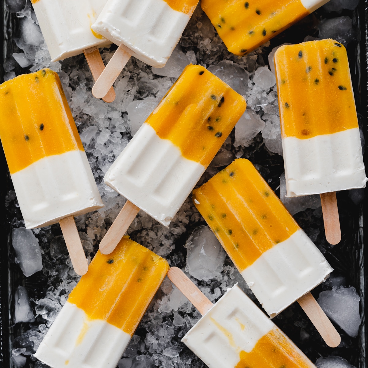 Don't Miss These Recipes Using Coconut Yogurt 7 a tray of orange and white popsicles made with coconut yogurt surrounded by ice